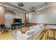 Living room featuring hardwood floors, exposed brick, ductwork, and a media center at 21 E 6Th St # 311, Tempe, AZ 85281
