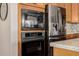 Close-up of the kitchen appliances, including a microwave, oven, and refrigerator at 22318 N Pico Ct, Sun City West, AZ 85375