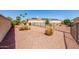 Spacious fenced backyard with desert landscaping, mature palm trees, and solar panels for energy efficiency at 22318 N Pico Ct, Sun City West, AZ 85375