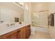 Relaxing bathroom showcasing a single vanity, granite countertops and a shower with glass door at 22318 N Pico Ct, Sun City West, AZ 85375