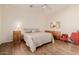 Bright bedroom features wood floors, a ceiling fan, and neutral decor at 22318 N Pico Ct, Sun City West, AZ 85375
