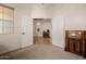 Open bonus room with neutral walls, an antique radio, and double doors that lead into another living space at 22318 N Pico Ct, Sun City West, AZ 85375