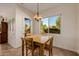 Bright dining area with a view of the backyard through a large window at 22318 N Pico Ct, Sun City West, AZ 85375