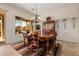 An elegant dining room features a wood table, chairs, and a decorative chandelier at 22318 N Pico Ct, Sun City West, AZ 85375