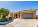 Elegant home features multiple garage spaces and desert landscaping, ensuring ample parking and curb appeal at 22318 N Pico Ct, Sun City West, AZ 85375