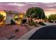 Well-maintained home featuring manicured landscaping, desert rock and native plants surrounding a welcoming exterior at 22318 N Pico Ct, Sun City West, AZ 85375