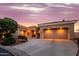 Elegant home features multiple garage spaces and desert landscaping, ensuring ample parking and curb appeal at 22318 N Pico Ct, Sun City West, AZ 85375