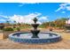 Exterior fountain view of the tiered water feature overlooking a meticulously maintained golf course at 22318 N Pico Ct, Sun City West, AZ 85375