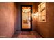 Inviting entryway with secure wrought iron door and decorative 'welcome' mat offering a glimpse into the home's interior at 22318 N Pico Ct, Sun City West, AZ 85375