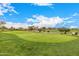 Lush green golf course with visible golf carts and manicured landscaping at 22318 N Pico Ct, Sun City West, AZ 85375