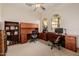 Spacious home office with built-in wooden desks and cabinetry, perfect for remote work or study at 22318 N Pico Ct, Sun City West, AZ 85375