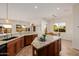 Spacious kitchen featuring an island with granite countertop and views of the dining and living areas at 22318 N Pico Ct, Sun City West, AZ 85375