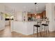 Kitchen featuring an island with barstool seating and modern appliances at 22318 N Pico Ct, Sun City West, AZ 85375
