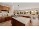 Open concept kitchen with a central island, granite countertops, and stainless steel appliances at 22318 N Pico Ct, Sun City West, AZ 85375