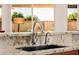 Modern kitchen sink with granite countertops and stainless steel fixtures at 22318 N Pico Ct, Sun City West, AZ 85375