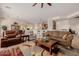 Open-concept living area with stylish seating, decorative rug, and seamless flow into the dining area and kitchen at 22318 N Pico Ct, Sun City West, AZ 85375