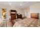 Spacious main bedroom with elegant wood furniture, media center, and stylish floors at 22318 N Pico Ct, Sun City West, AZ 85375