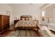Bright and spacious main bedroom with elegant furniture, decor, and wood floors at 22318 N Pico Ct, Sun City West, AZ 85375