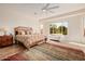 Bright main bedroom with ceiling fan, ample natural light, and stylish wood floors at 22318 N Pico Ct, Sun City West, AZ 85375