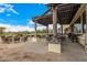 Expansive outdoor patio with pergola, seating, and views of the golf course on a sunny day at 22318 N Pico Ct, Sun City West, AZ 85375