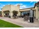 Outdoor patio area with dining tables, chairs, and patio heaters, perfect for entertaining with golf views at 22318 N Pico Ct, Sun City West, AZ 85375