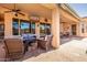 Inviting covered patio with comfortable seating, an outdoor television, and a dining area for relaxed entertaining at 22318 N Pico Ct, Sun City West, AZ 85375