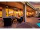 Inviting covered patio featuring comfortable seating, ceiling fans, and outdoor television for relaxed entertaining at 22318 N Pico Ct, Sun City West, AZ 85375