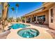 Inviting pool and spa with swaying palm trees create a serene backyard oasis for relaxation and entertainment at 22318 N Pico Ct, Sun City West, AZ 85375