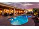 Sparkling pool adjacent to covered patio, perfect for outdoor dining and entertaining guests at 22318 N Pico Ct, Sun City West, AZ 85375