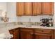 Wet bar with stylish cabinetry, wine rack, and granite countertops perfect for entertaining guests at 22318 N Pico Ct, Sun City West, AZ 85375