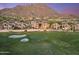 Scenic aerial view showcases luxurious homes lining the golf course, nestled by rocky mountains at 25150 N Windy Walk Dr # 37, Scottsdale, AZ 85255