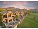 Aerial shot of luxurious homes overlooking a golf course against a majestic mountain backdrop at 25150 N Windy Walk Dr # 37, Scottsdale, AZ 85255