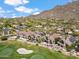 Aerial view of a golf course community with luxury homes, mountain views, and lush green fairways at 25150 N Windy Walk Dr # 37, Scottsdale, AZ 85255