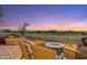 Relaxing back patio with a fire pit, comfortable chairs, and stunning golf course vistas at 25150 N Windy Walk Dr # 37, Scottsdale, AZ 85255