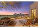 Inviting back patio with lounge chairs, desert landscaping, and mountain views at sunset at 25150 N Windy Walk Dr # 37, Scottsdale, AZ 85255