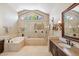 This bathroom boasts a soaking tub, glass enclosed shower, and a vanity with a sink at 25150 N Windy Walk Dr # 37, Scottsdale, AZ 85255