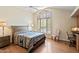 Charming bedroom with vaulted ceiling, plantation shutters, wood floors, and southwestern decor at 25150 N Windy Walk Dr # 37, Scottsdale, AZ 85255