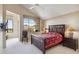 This bedroom features a large bed, vaulted ceiling, and scenic views at 25150 N Windy Walk Dr # 37, Scottsdale, AZ 85255