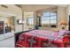 Spacious bedroom featuring a large bed, natural light, and access to a balcony overlooking the views at 25150 N Windy Walk Dr # 37, Scottsdale, AZ 85255