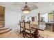 Open-concept dining area with a large wood table, stylish chandelier, and access to the kitchen and living areas at 25150 N Windy Walk Dr # 37, Scottsdale, AZ 85255