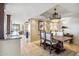 Elegant dining room features a rustic wood table, chandelier, and an open view of the living space at 25150 N Windy Walk Dr # 37, Scottsdale, AZ 85255