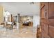 Grand entryway showcases tile floors, wood columns, open dining area, and a glimpse of the kitchen at 25150 N Windy Walk Dr # 37, Scottsdale, AZ 85255