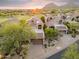 Exterior shot of a home with a two car garage, desert landscaping, and mountain views at 25150 N Windy Walk Dr # 37, Scottsdale, AZ 85255