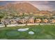 Scenic view of stucco homes with a golf course, mountain views, and mature landscaping at 25150 N Windy Walk Dr # 37, Scottsdale, AZ 85255