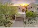 Home exterior with a two car garage and desert landscaping at 25150 N Windy Walk Dr # 37, Scottsdale, AZ 85255
