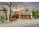 Charming home exterior with a two car garage, desert landscaping and bougainvillea at 25150 N Windy Walk Dr # 37, Scottsdale, AZ 85255