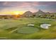 Lush golf course view at sunset with sand traps and views of the mountains in the background at 25150 N Windy Walk Dr # 37, Scottsdale, AZ 85255