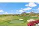 Stunning golf course view, showcasing the putting green, sand traps, and mountain views in the background at 25150 N Windy Walk Dr # 37, Scottsdale, AZ 85255