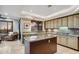 Open kitchen with granite countertops, central island, stainless steel appliances, and views to the living room at 25150 N Windy Walk Dr # 37, Scottsdale, AZ 85255