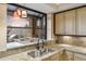Kitchen bar with granite countertops, stainless steel sink, and views of an outdoor kitchen at 25150 N Windy Walk Dr # 37, Scottsdale, AZ 85255